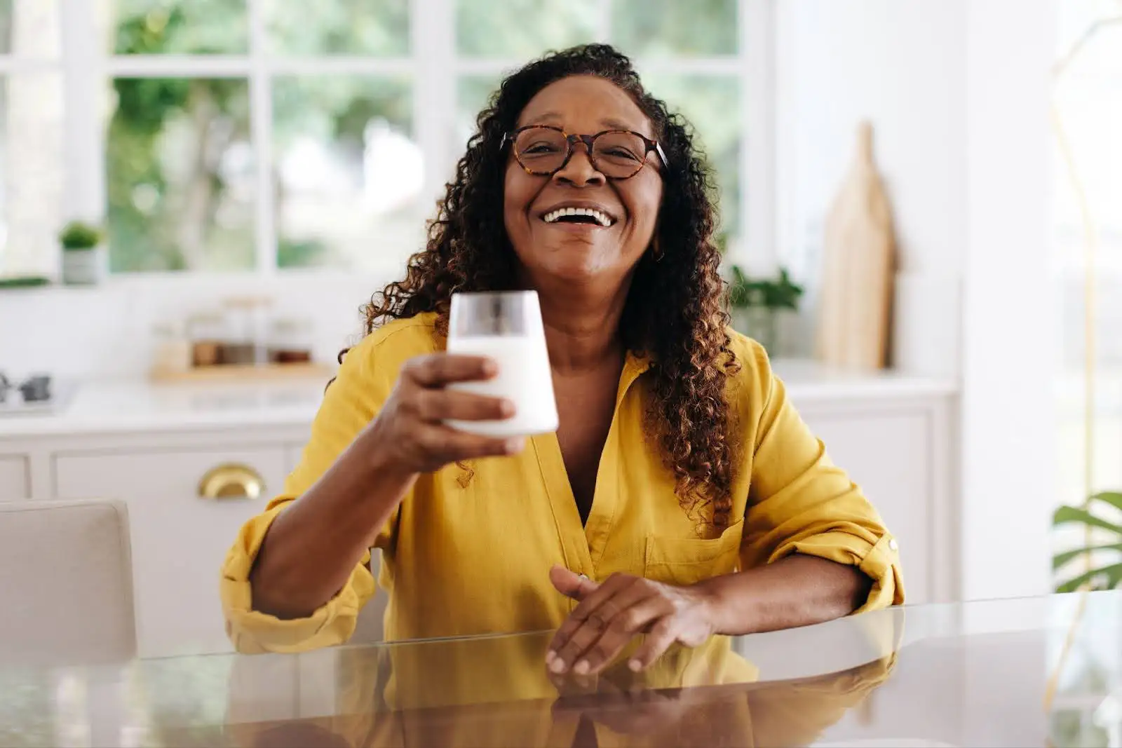 Senior woman drinking a glass of milk